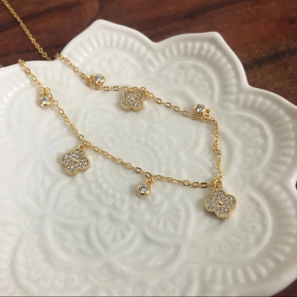 gold dangle station necklace encrusted clover charm round bezel set Cubic Zircon